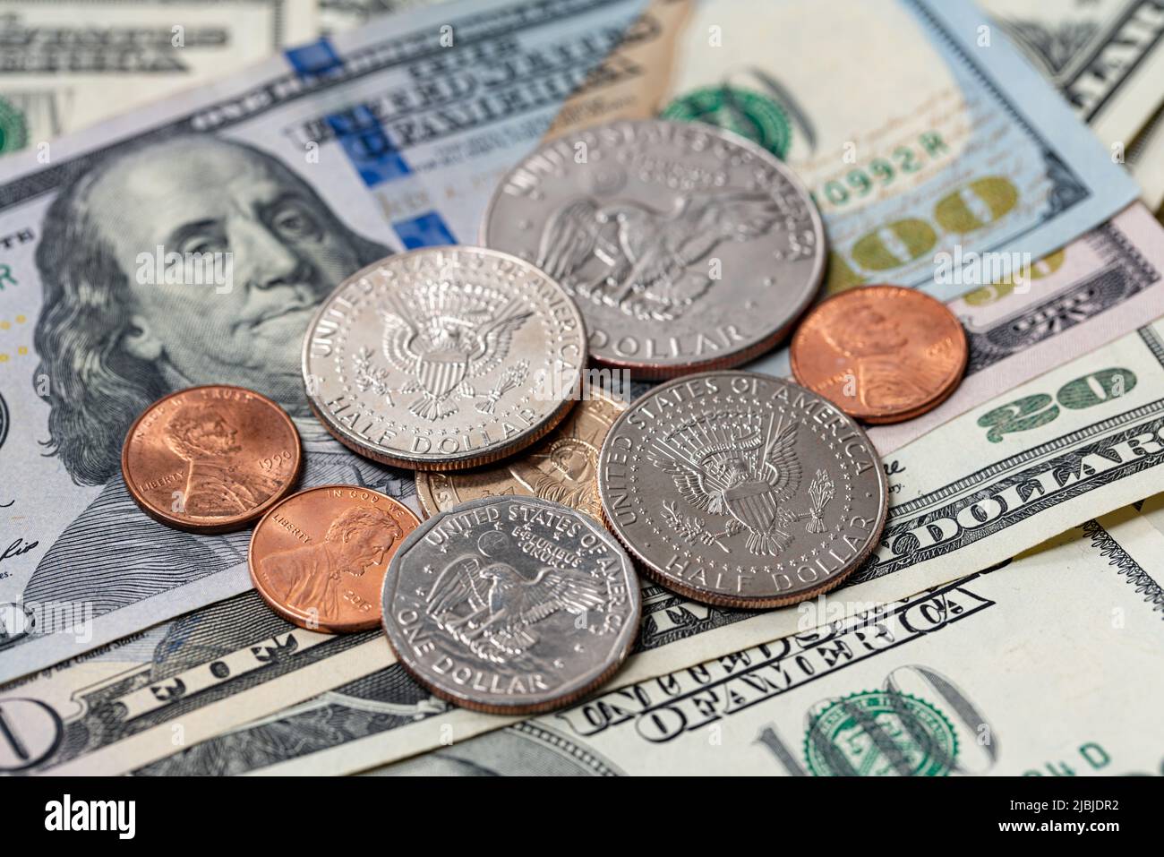 Half Dollar and one dollar coins on top of USD banknotes. Coins and paper money. US Dollar cash, finance and economy in the United States of America Stock Photo - Alamy